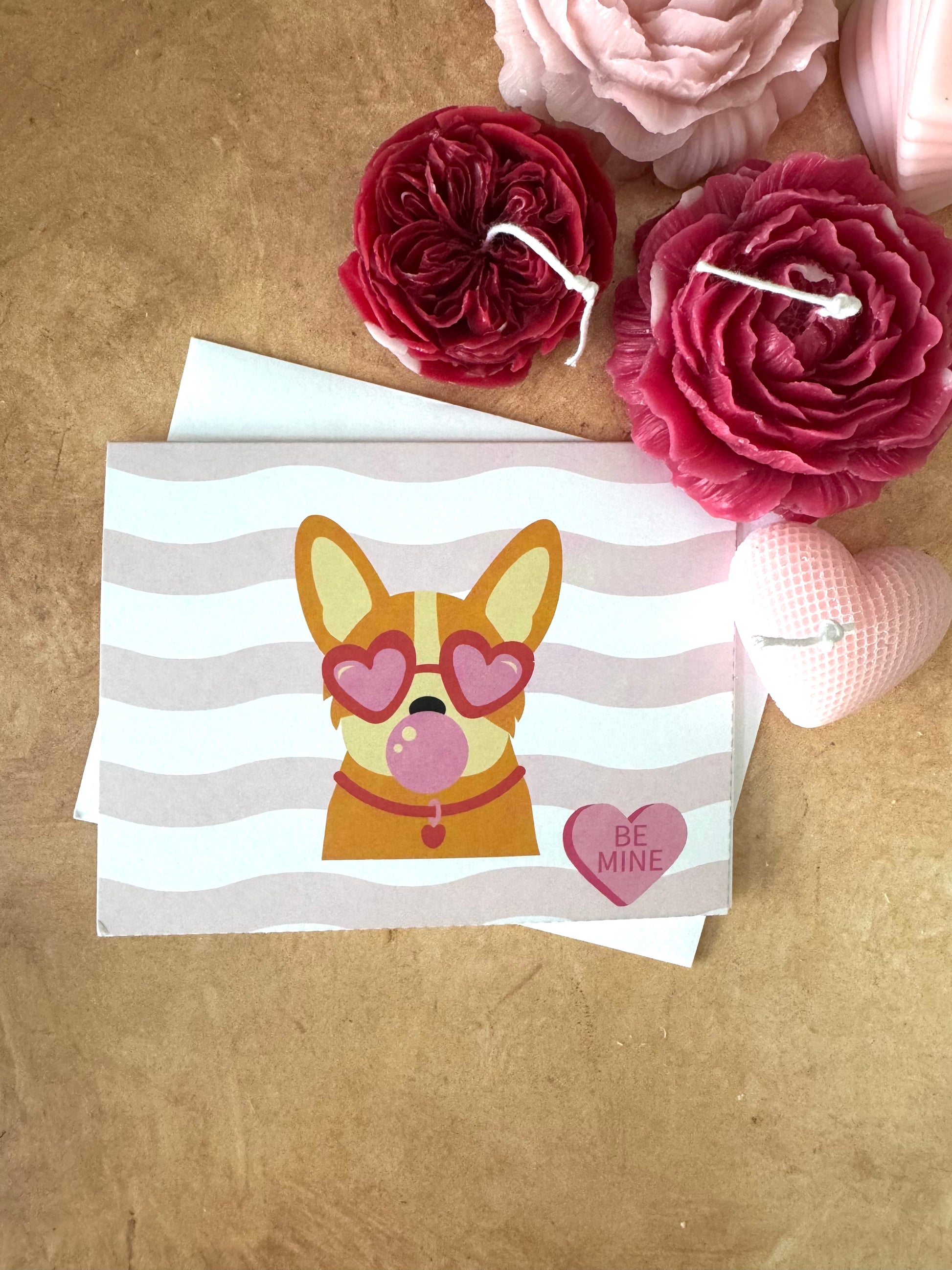 Valentine's Day card with a dog illustration and heart-shaped glasses on a brown background with flowers.