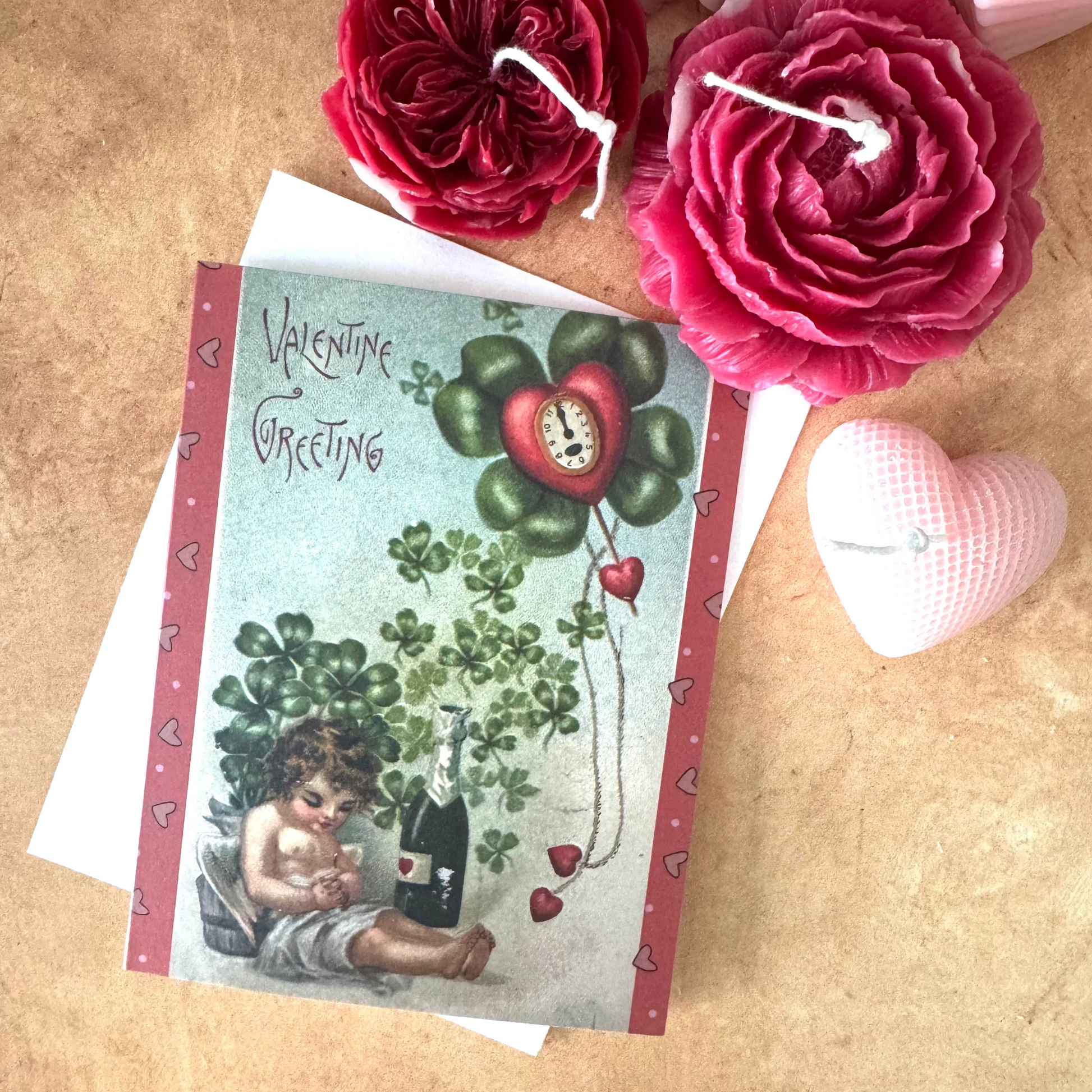 Vintage Valentine's Day card with red flowers on a wooden surface