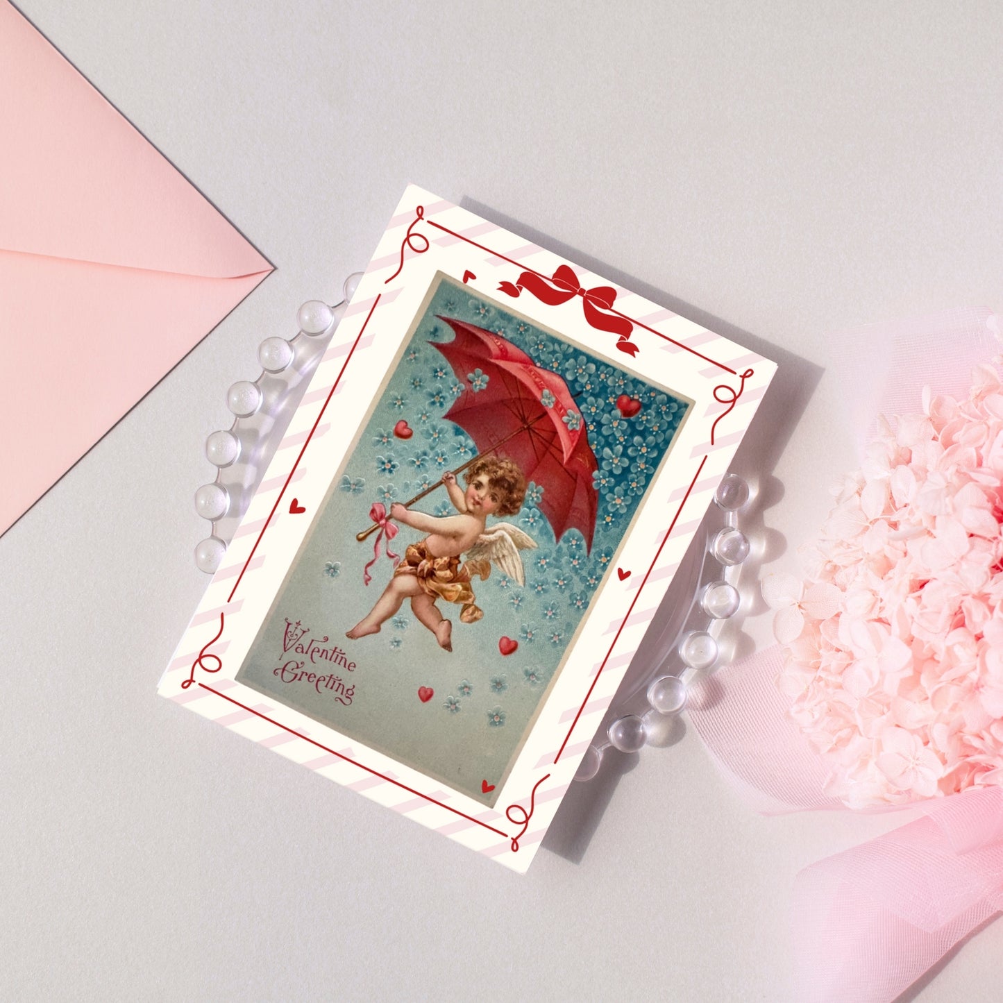 Valentine's Day card with Cupid and red heart design on a light gray background